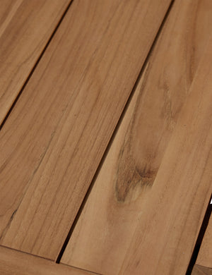 Close up of the woodgrain of the Abbot solid teak rectangular outdoor dining table by Sarah Sherman Samuel.