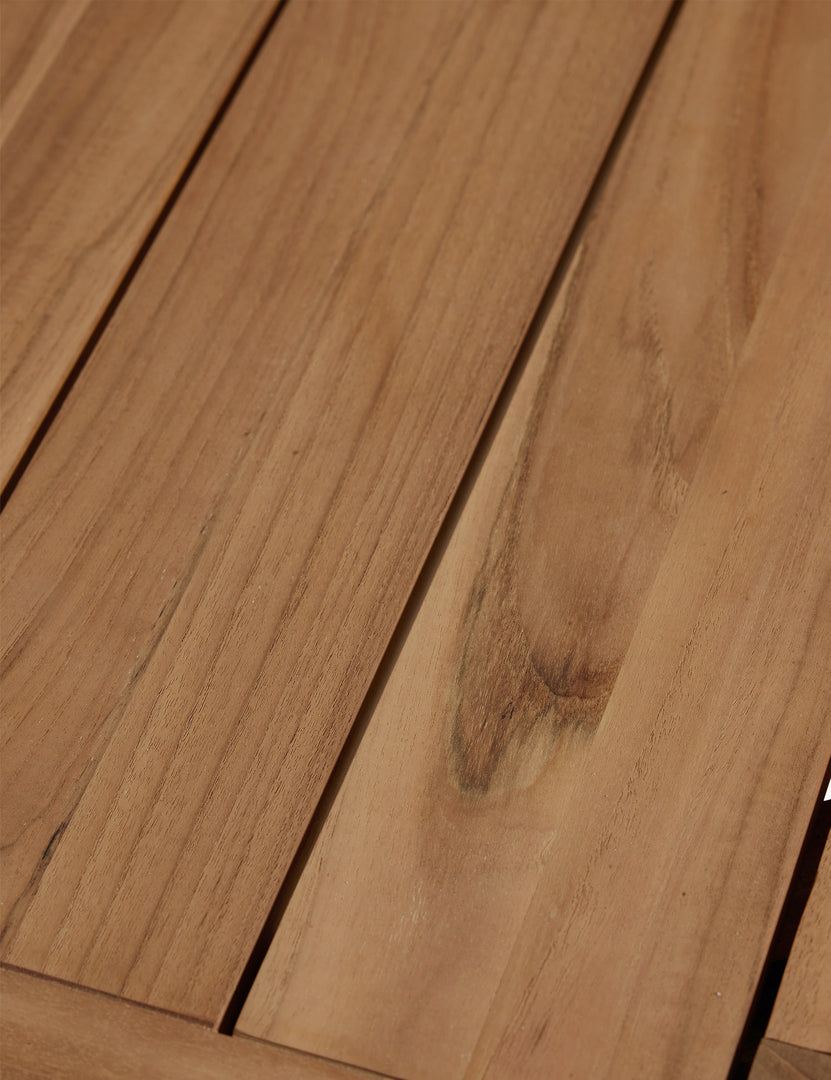 #color::natural-teak | Close up of the woodgrain of the Abbot solid teak rectangular outdoor dining table by Sarah Sherman Samuel.