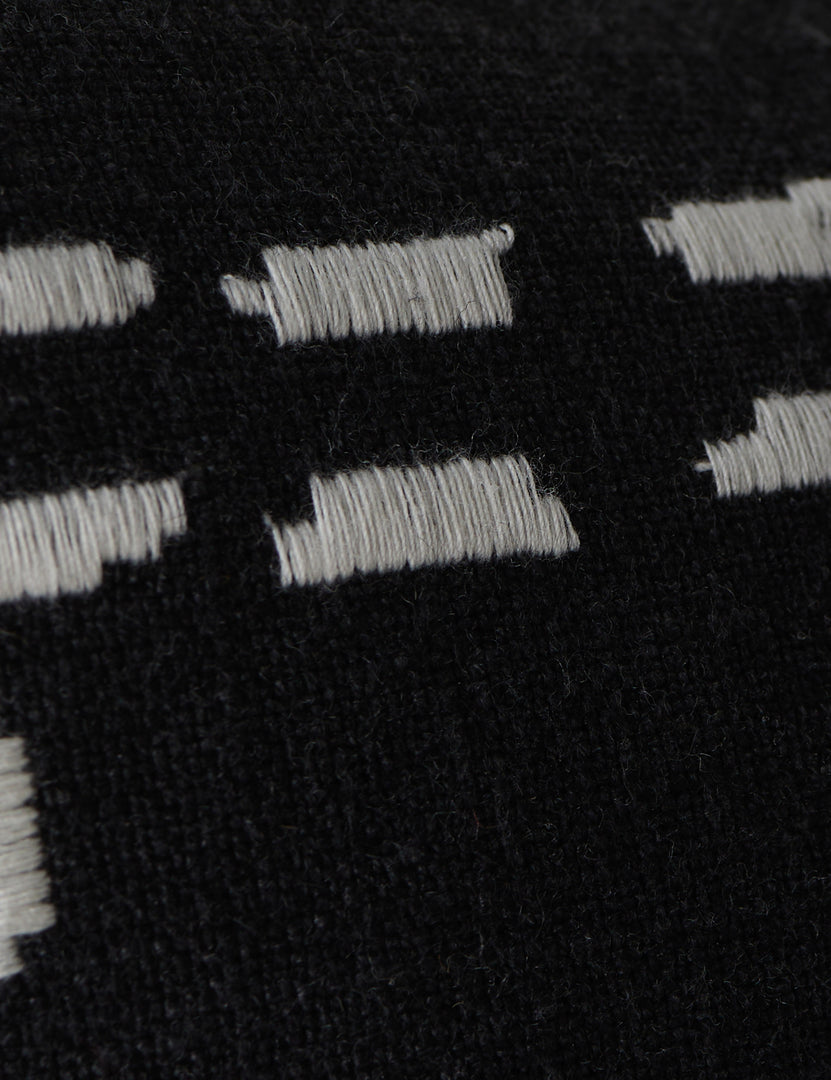 #style::black-lumbar | Close up view of the pattern of the Accord Black Linen Lumbar Pillow by Elan Byrd.