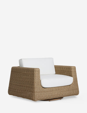Angled view of the Aisha wide arm modern wicker outdoor swivel chair.