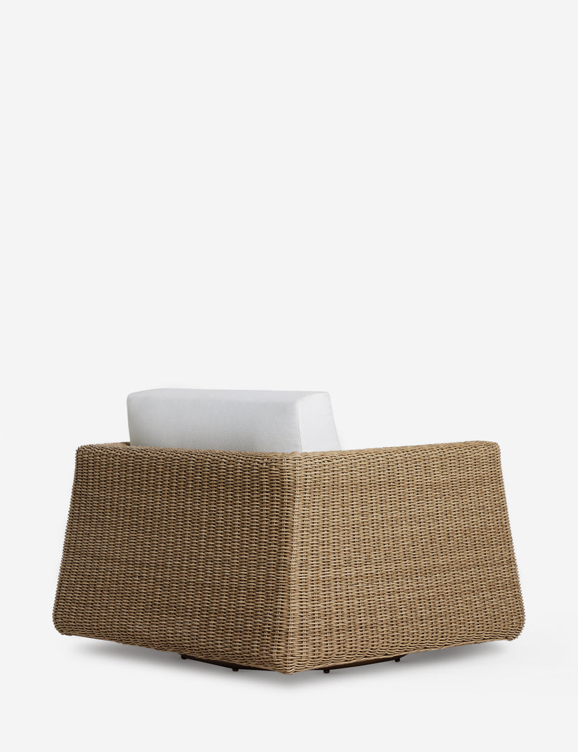 #color::natural | Angled back view of the Aisha wide arm modern wicker outdoor swivel chair.