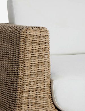 Close up of the arm of the Aisha wide arm modern wicker outdoor swivel chair.