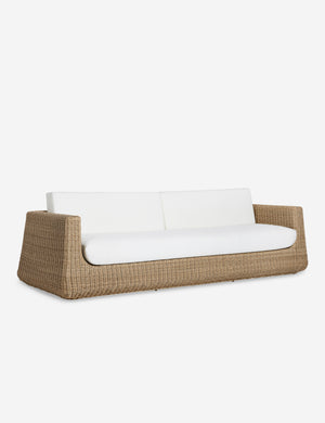 Angled view of the Aisha wide arm modern wicker outdoor sofa.