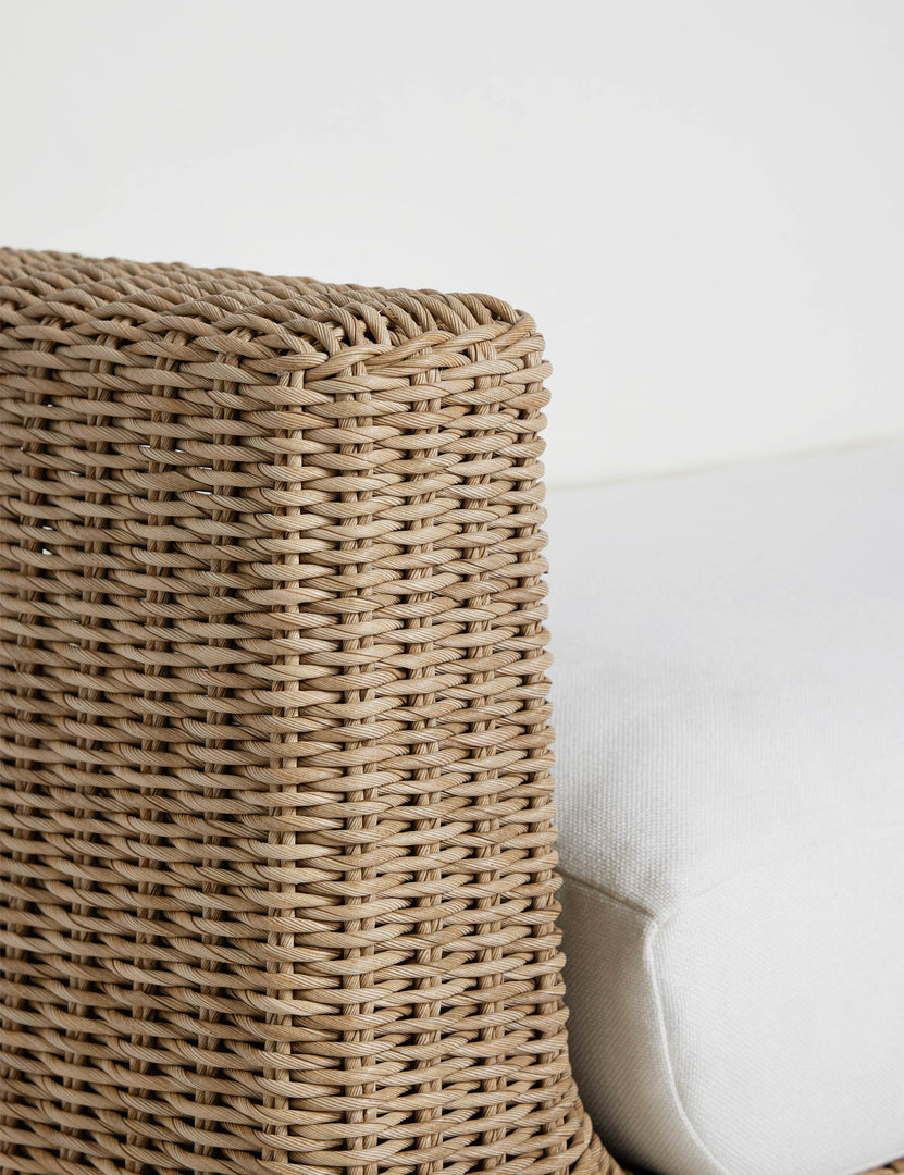 #color::natural | Close up of the wicker frame of the Aisha wide arm modern wicker outdoor sofa.