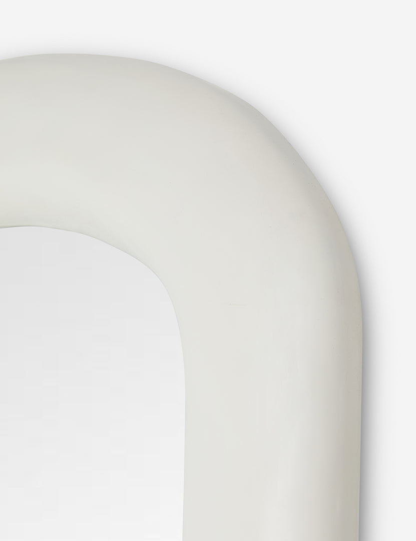 #color::white | Top corner of the Alston white oval full length mirror.