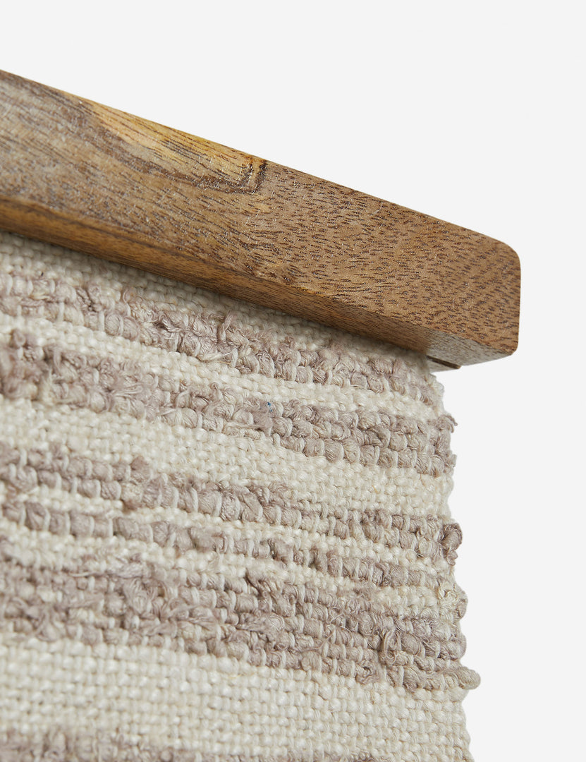 #color::natural | Close up of the frame of the Alvah handwoven textural striped textile wall hanging.