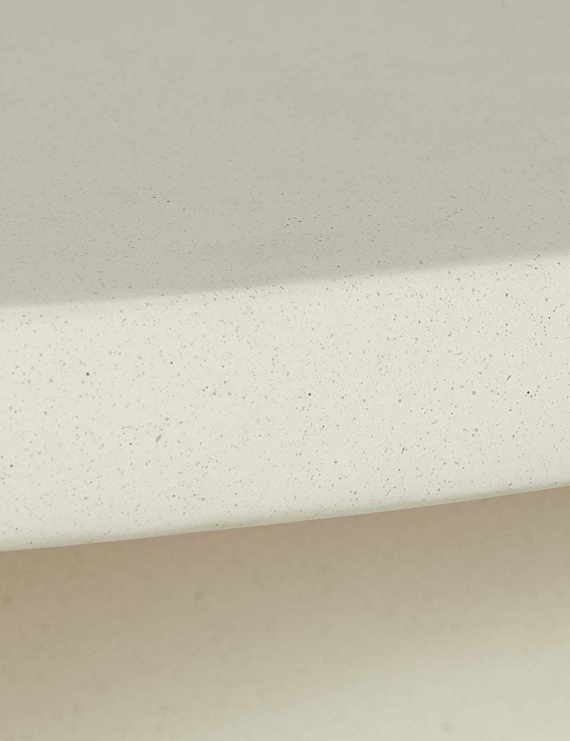 #color::ivory | Close up of the finish of the Amaya round sculptural cement coffee table.