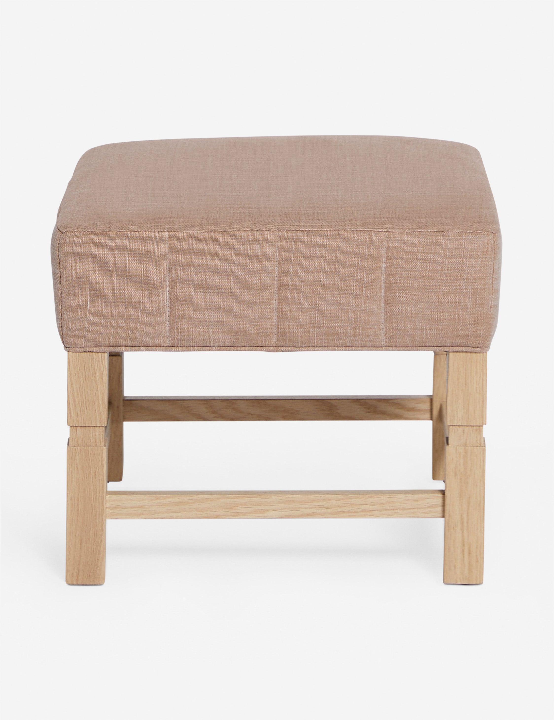 #color::apricot-linen | Ambleside Apricot linen upholstered ottoman by Ginny Macdonald with a carved frame and vertical channeling on the cushion