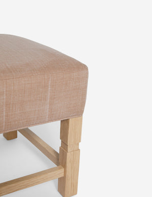 Close-up of the corner on the cushion of the Ambleside Apricot linen ottoman