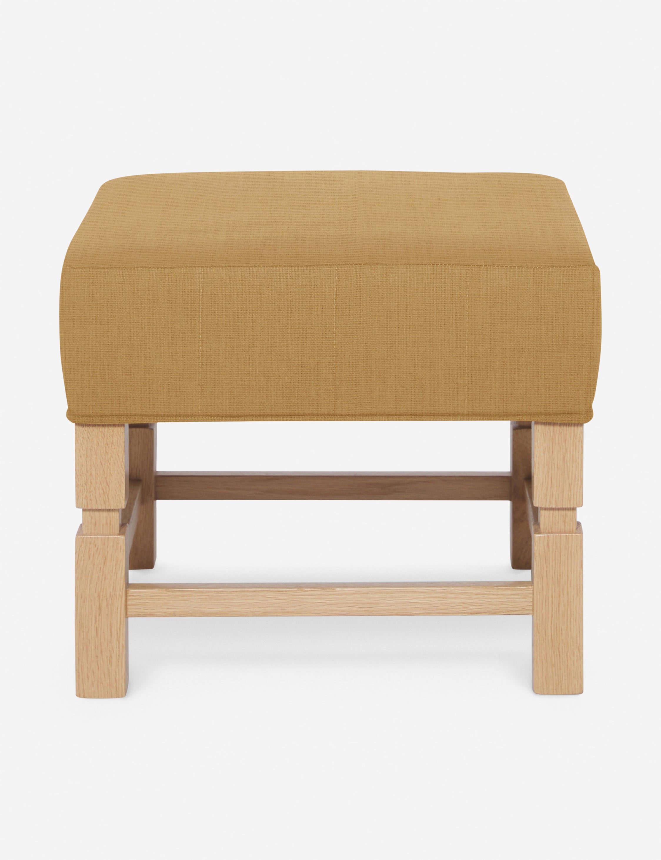 #color::camel-linen | Ambleside Camel yellow linen upholstered ottoman by Ginny Macdonald with a carved frame and vertical channeling on the cushion