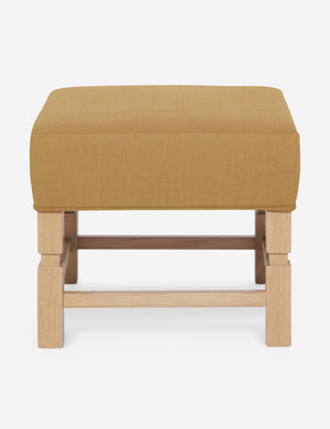 Ambleside Camel yellow linen upholstered ottoman by Ginny Macdonald with a carved frame and vertical channeling on the cushion