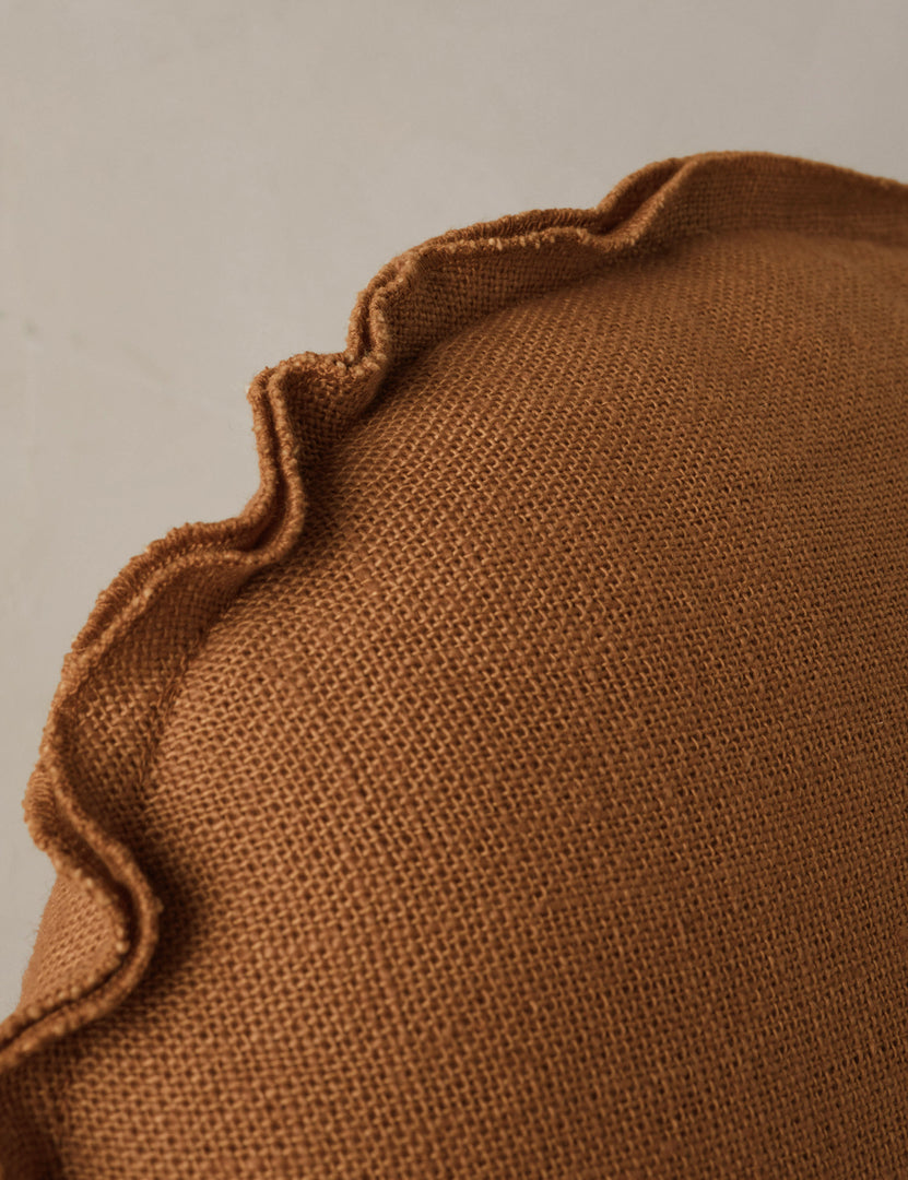 #color::burnt-orange | Close up of the Arlo linen flange trim round pillow.
