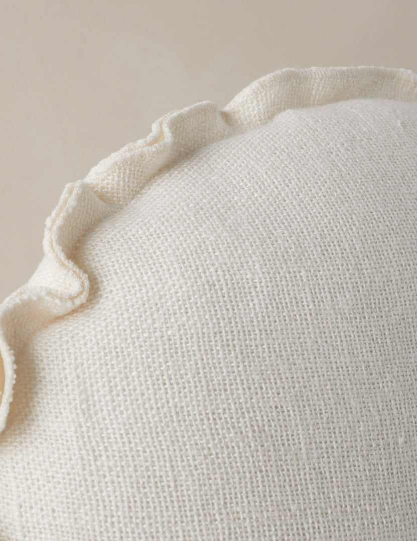 #color::ivory | Close up of the Arlo linen flange trim round pillow.