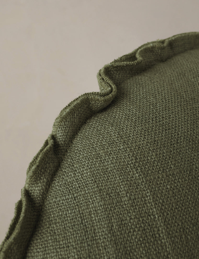 #color::olive | Close up of the Arlo linen flange trim round pillow.