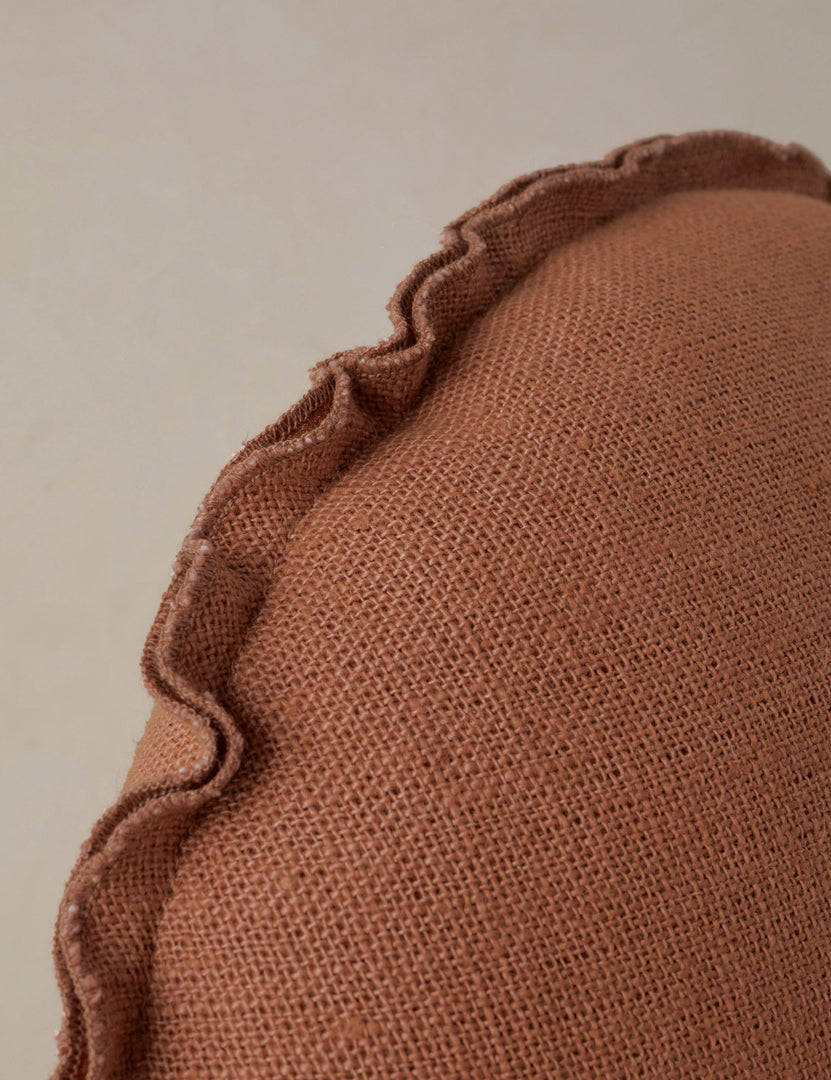 #color::rust | Close up of the Arlo linen flange trim round pillow.