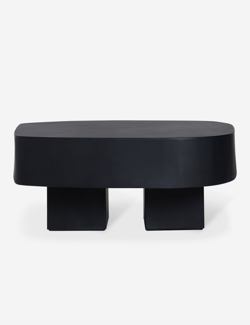 #color::black | Side view of the Armas black monolithic round outdoor coffee table by Sarah Sherman Samuel.