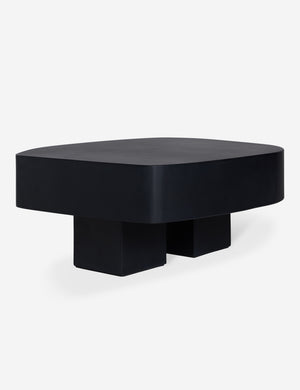 Angled view of the Armas black monolithic round outdoor coffee table by Sarah Sherman Samuel.