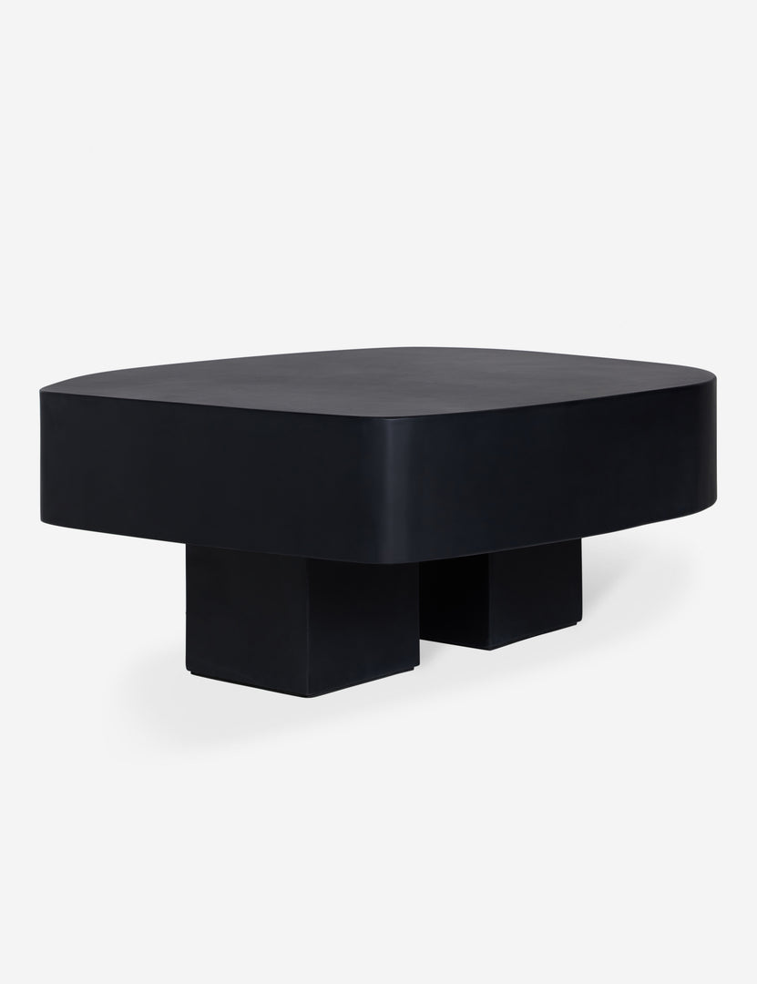 #color::black | Angled view of the Armas black monolithic round outdoor coffee table by Sarah Sherman Samuel.
