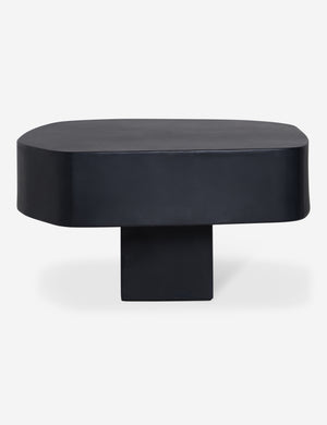 Side profile of the Armas black monolithic round outdoor coffee table by Sarah Sherman Samuel.