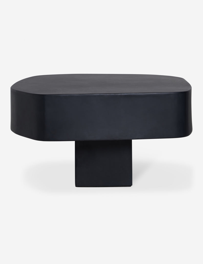 #color::black | Side profile of the Armas black monolithic round outdoor coffee table by Sarah Sherman Samuel.