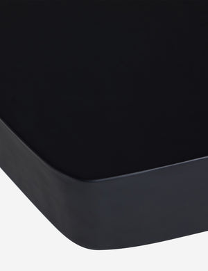 Close up of the Armas black monolithic round outdoor coffee table by Sarah Sherman Samuel.