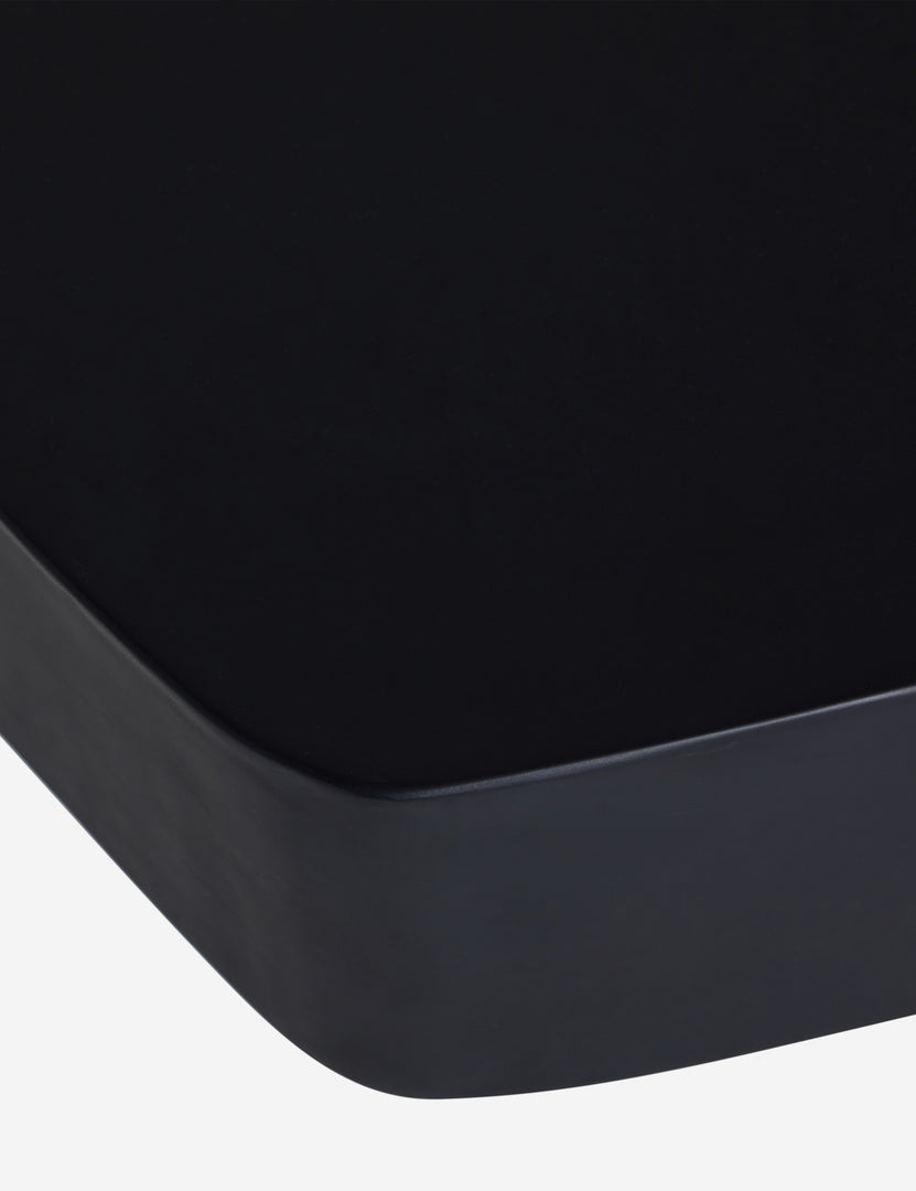 #color::black | Close up of the Armas black monolithic round outdoor coffee table by Sarah Sherman Samuel.