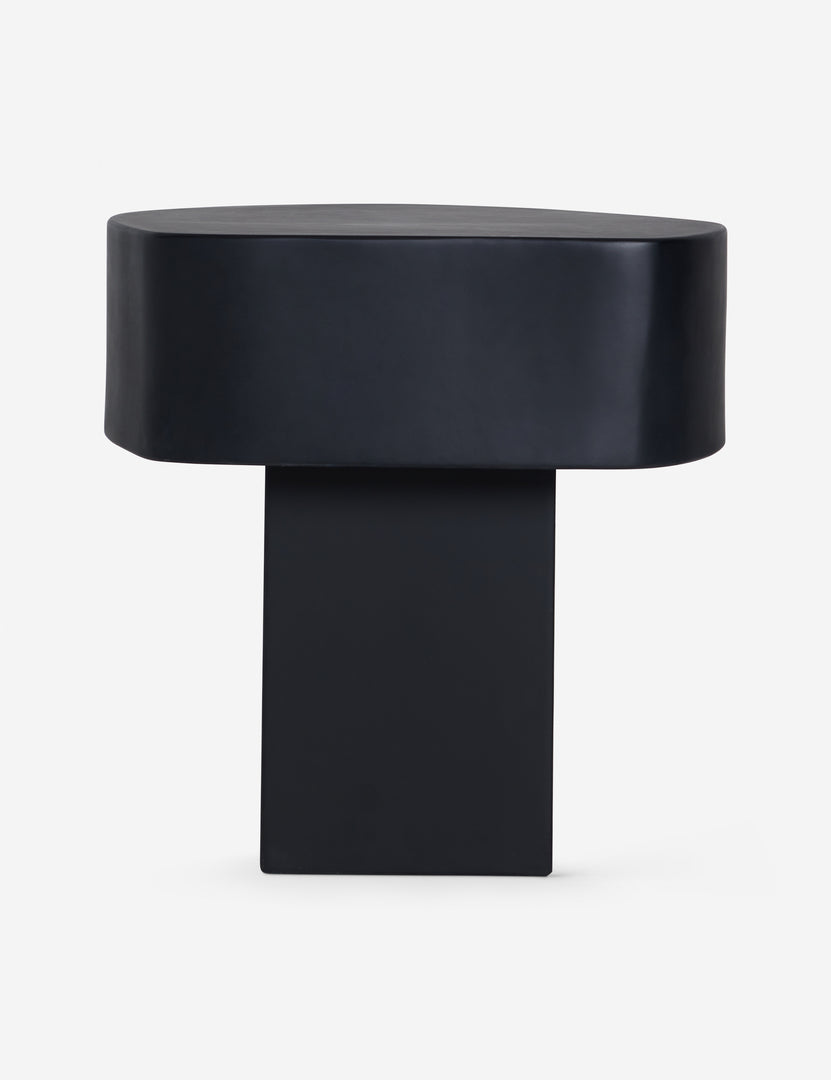 #color::black | Side profile of the Armas black monolithic round outdoor side table by Sarah Sherman Samuel.