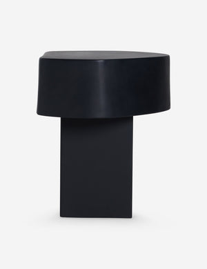 Side view of the Armas black monolithic round outdoor side table by Sarah Sherman Samuel.