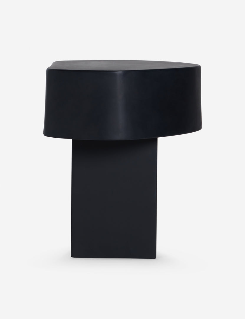#color::black | Side view of the Armas black monolithic round outdoor side table by Sarah Sherman Samuel.