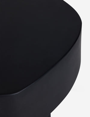 Close up of the Armas black monolithic round outdoor side table by Sarah Sherman Samuel.