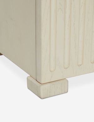Close up of the bottom of the Beck grooved light wood nightstand.