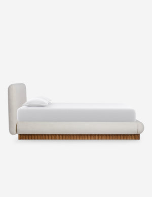 Side view of the Billow overstuffed boucle upholstered bed with wooden base
