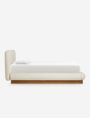 Side view of the Billow overstuffed boucle upholstered bed with wooden base