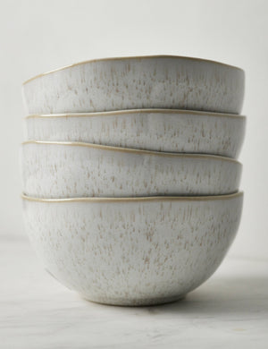 Side view of the Eivissa set of 6 shiny white glazed speckled stoneware cereal bowls by Casafina