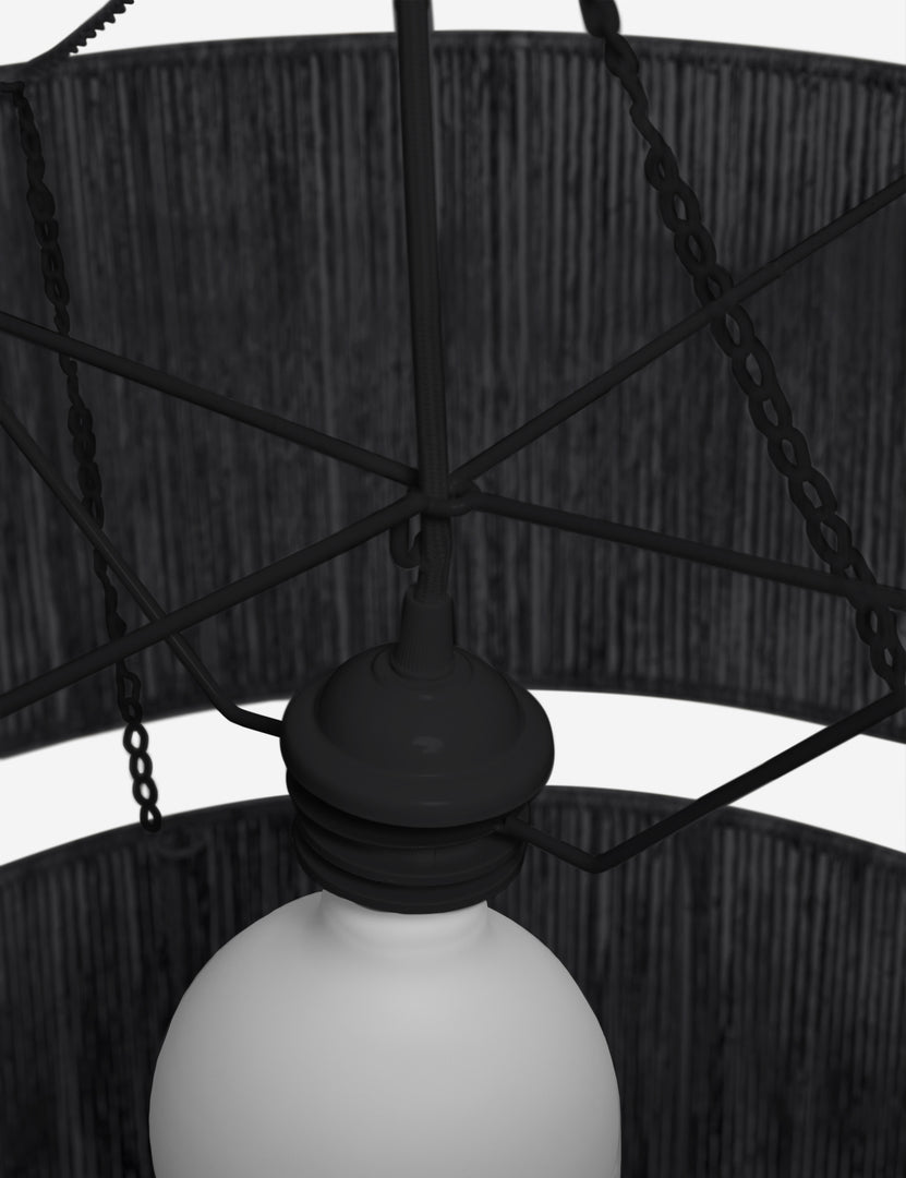 | Close-up of the light fixture on the Chavette three-tiered black jute-wrapped chandelier