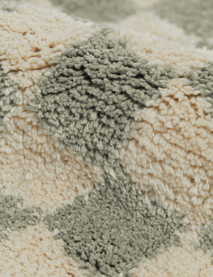 Close up view of the Two-tone checkerboard bath mat by Sarah Sherman in lichen green