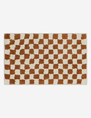Two-tone checkerboard bath mat by Sarah Sherman in rust umber