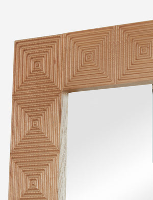 Corner of the Chelan handcrafted carved wood frame full length mirror.