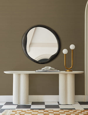 The Grasscloth olive green Solid Wallpaper is in a room with a black round mirror, checkerboard floors, and a white side table