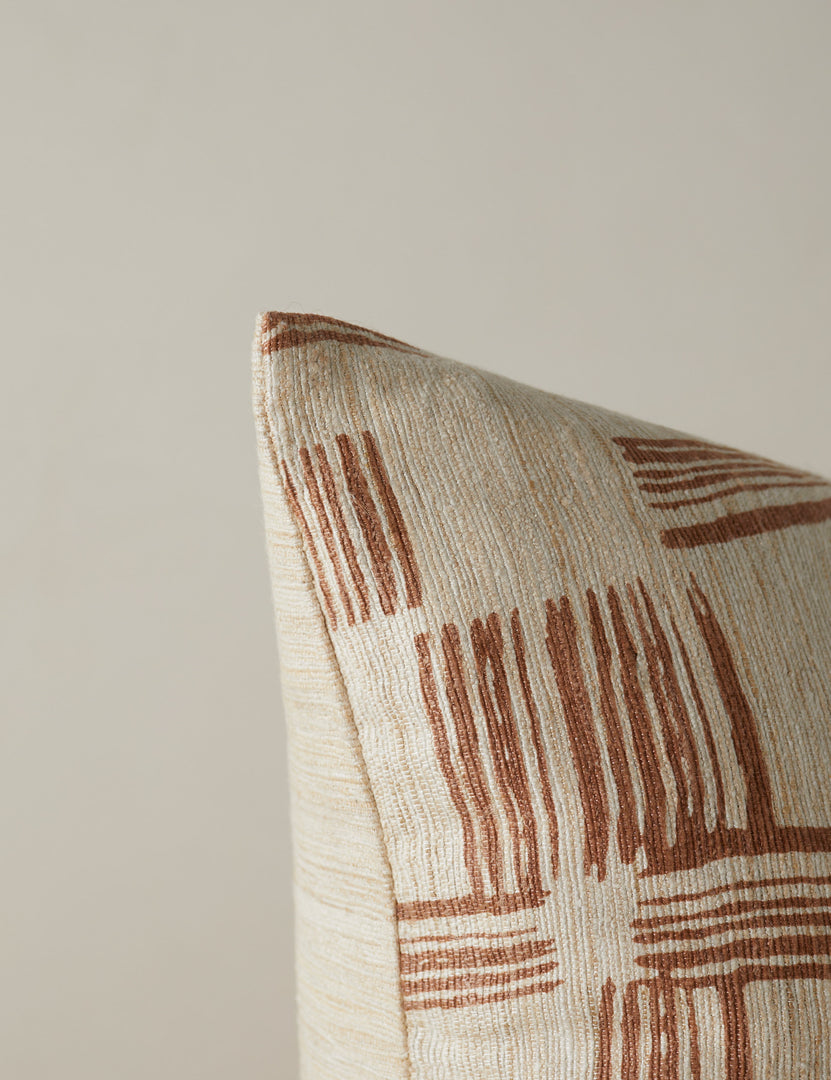 #color::terracotta | Corner of the Crossmarks Silk Pillow by Elan Byrd in terracotta.