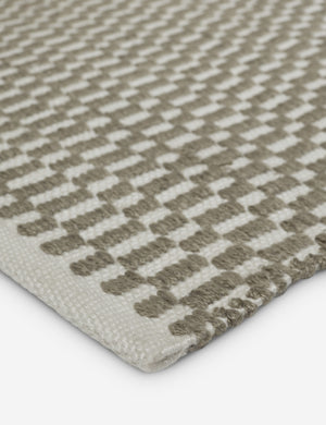 Close up of the corner of the Dante handwoven checkerboard outdoor rug.