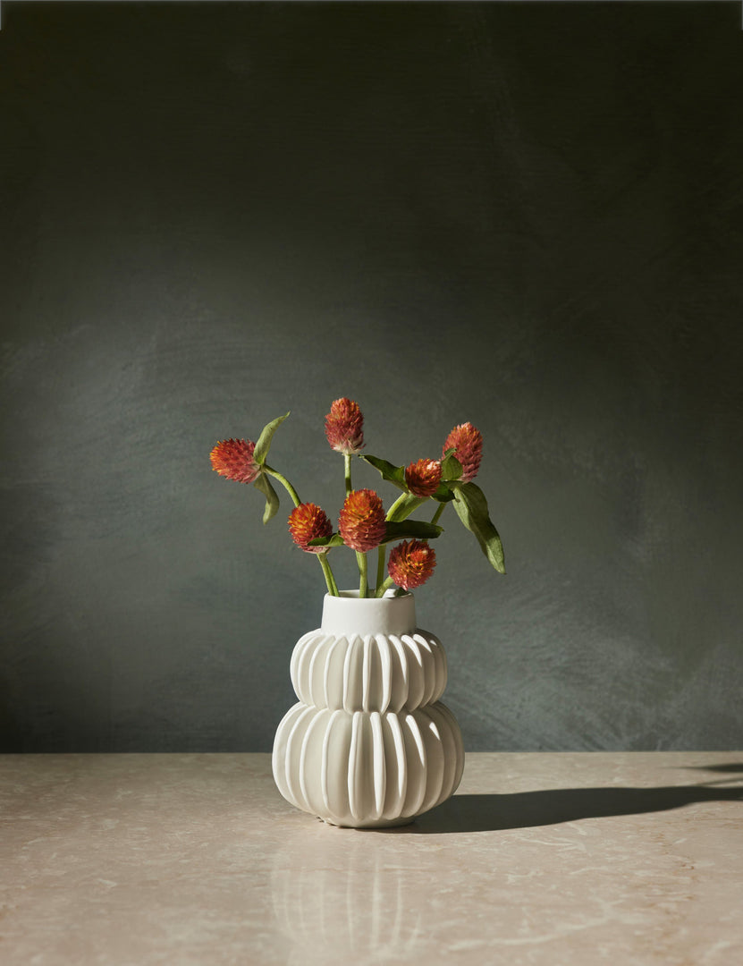 #color::white | Delilah white ceramic vase featuring two rows of half-moon discs fanned around a tapered body with flowers inside of itDelilah white ceramic vase featuring two rows of half-moon discs fanned around a tapered body with flowers inside of it