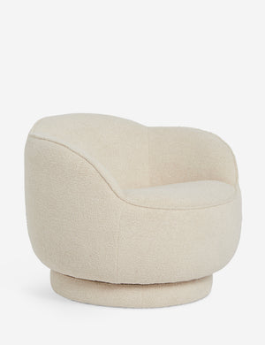 Angled view of the Fern scalloped back boucle upholstered swivel chair