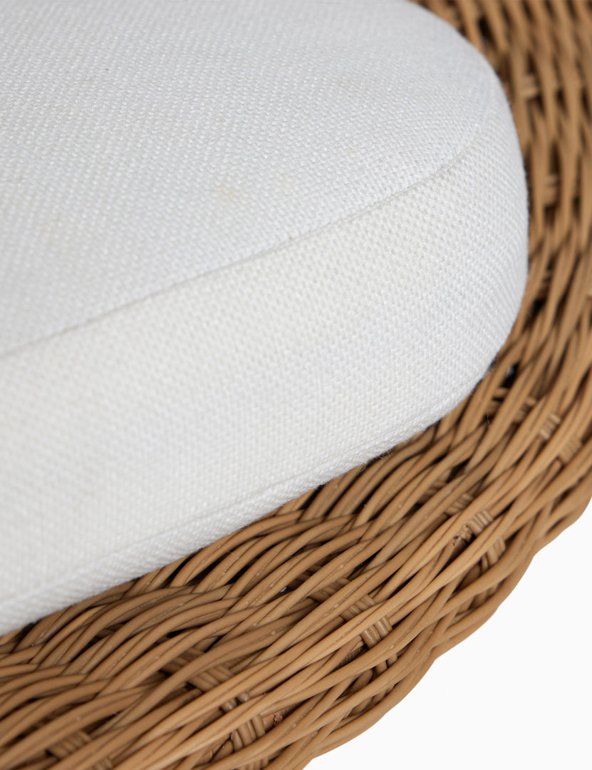 #color::natural | Close up of the seat cushion of the Ferran sculptural wicker outdoor accent chair.