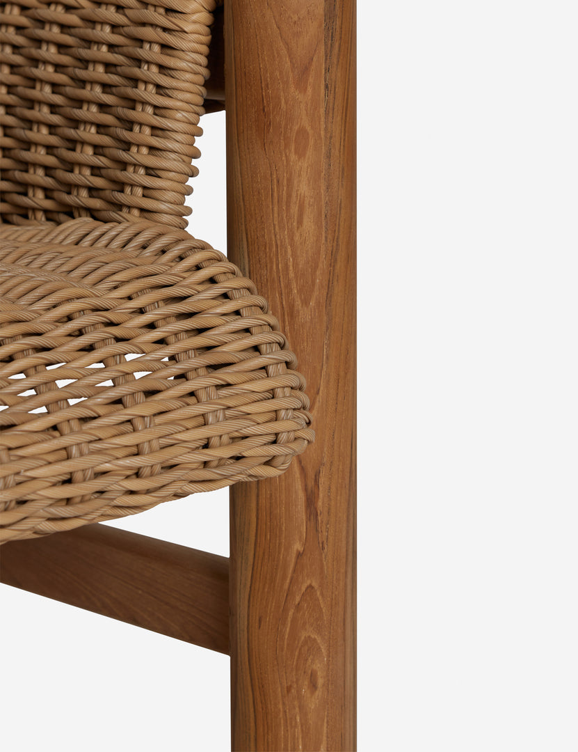 #color::natural | Close up of the Gally wicker and teak outdoor accent chair.