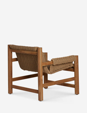Angled back view of teh Gally wicker and teak outdoor accent chair.