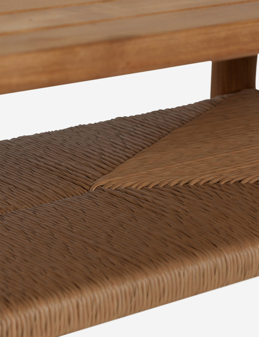 #color::natural | Close up of the shelf of the Gally teak and wicker outdoor coffee table.