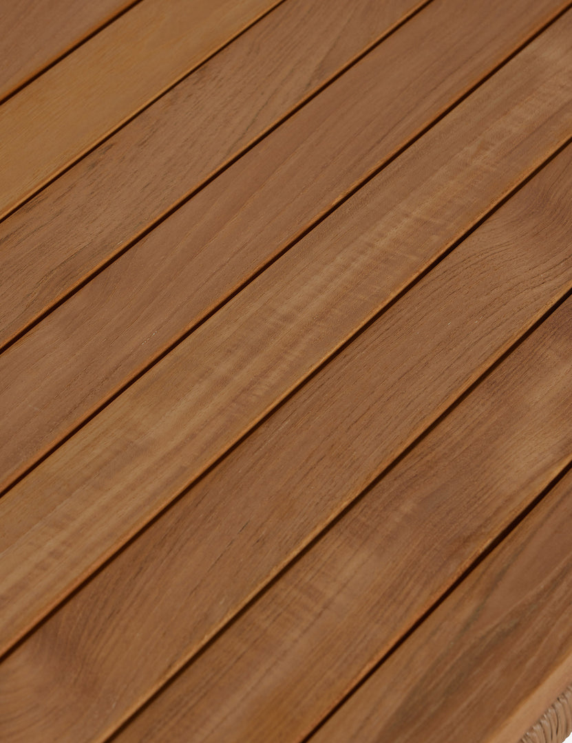 #color::natural | Close up of the slatted top of the Gally teak and wicker outdoor coffee table.