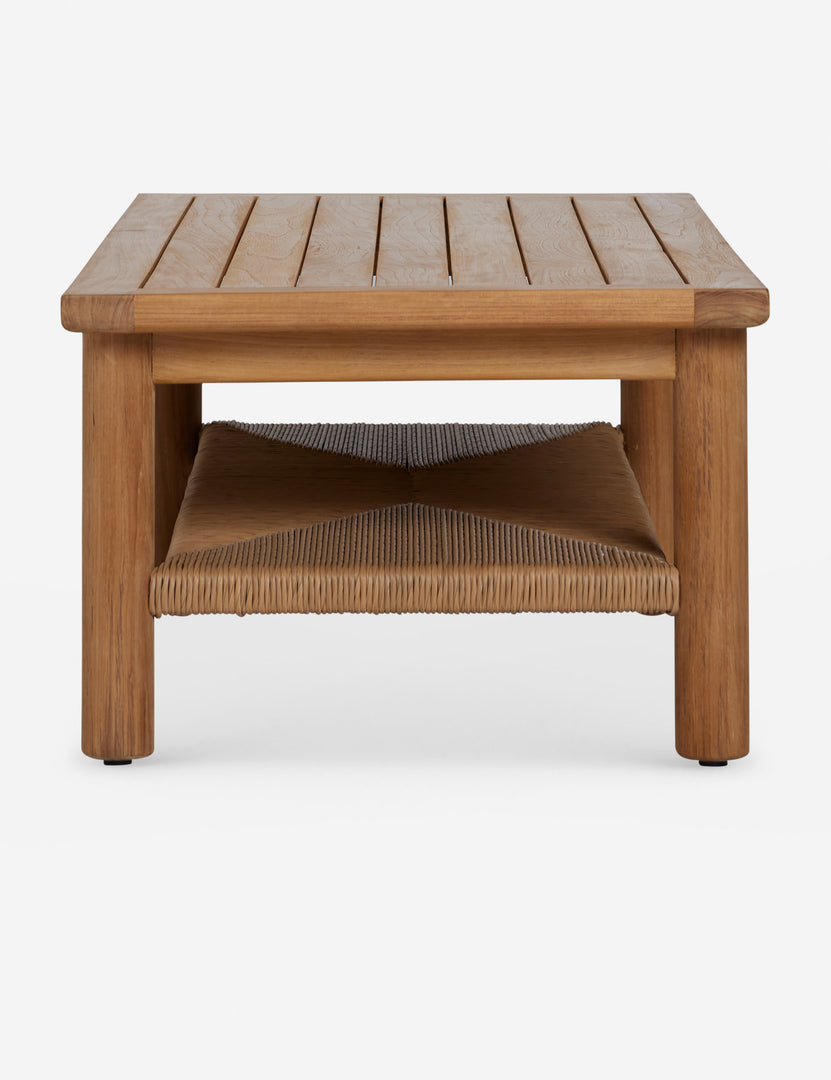 #color::natural | Side profile of the Gally teak and wicker outdoor coffee table.