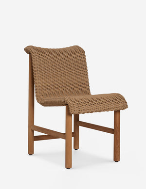 Angled view of the Gally wicker and teak outdoor dining chair.